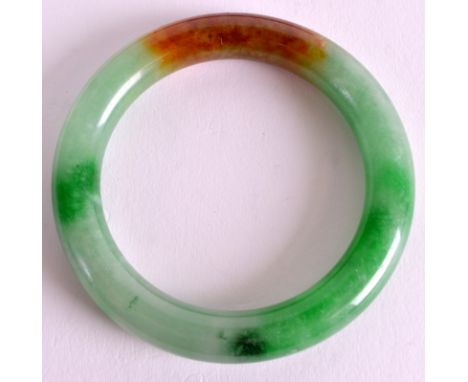 A FINE 19TH CENTURY CHINESE CARVED JADE BANGLE of circular form, with natural inclusions and colour spectrum. 3.25ins diamete