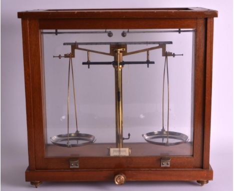 A PAIR OF 1950S CASED APOTHACARY TYPE SCALES BY Philip Harris LTD of Birmingham. 1ft 3ins wide.