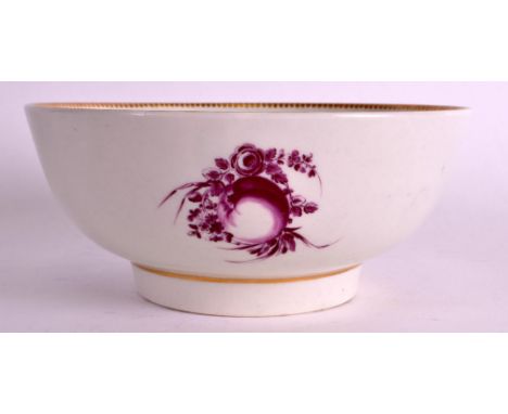 AN 18TH CENTURY WORCESTER BOWL painted in puce with scattered fruit. 6.5ins diameter.