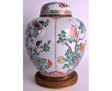 A 19TH CENTURY FRENCH SAMSONS OF PARIS GINGER JAR AND COVER Kangxi style, painted with bold enamels over flowering rock, unde