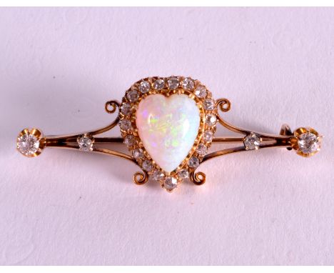 A FINE VICTORIAN 15CT YELLOW GOLD HEART SHAPED OPAL AND DIAMOND BROOCH naturally formed and encased with old cut diamonds. 6.