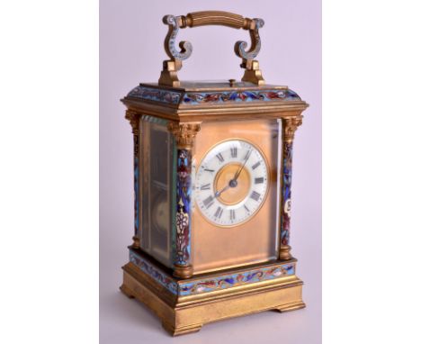 A LATE 19TH CENTURY FRENCH CHAMPLEVE ENAMEL CARRIAGE CLOCK with elaborate floral mounts and a circular cream panel. 8.5ins hi