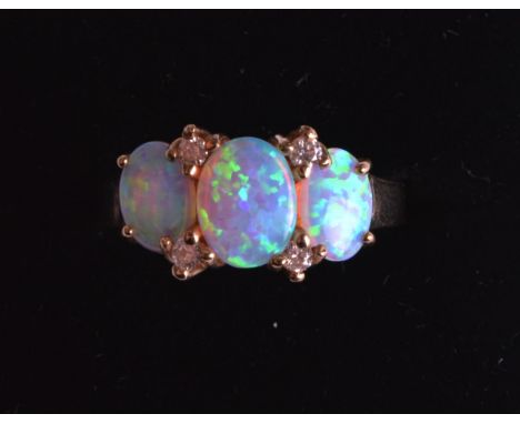 A LOVELY LADIES 9CT YELLOW GOLD THREE STONE DIAMOND AND OPAL ETERNITY RING. 4.2grams.