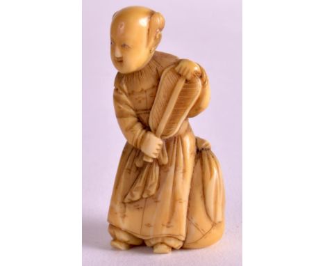 A 19TH CENTURY JAPANESE MEIJI PERIOD CARVED IVORY NETSUKE depicting a standing female holding a fan. 1.75ins high.