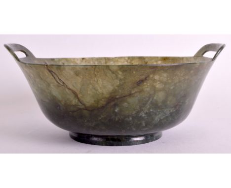 A 19TH CENTURY CHINESE CARVED SPINACH JADE TWIN HANDLED BOWL Qing, of flared form. 6.5ins diameter.