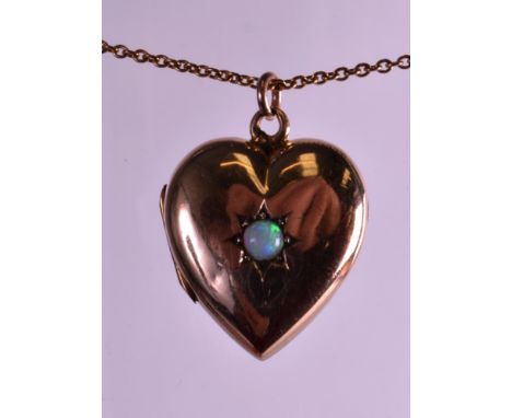 A VICTORIAN 9CT YELLOW GOLD HEART SHAPED LOCKET SET with natural opal and 9ct gold chain. 