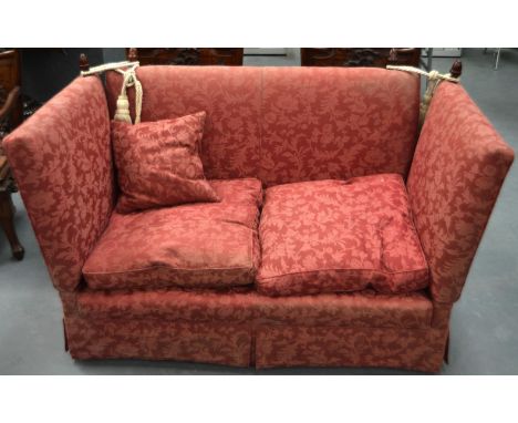 A TWO SEATER RED UPHOLSTERED GOOD QUALITY SOFA with turned wood finials. 4ft 11ins wide.