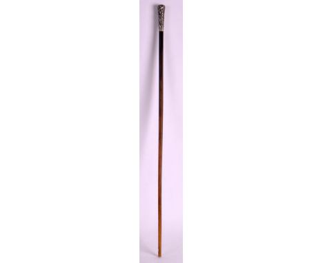 A 19TH CENTURY INDIAN CARVED RHINOCEROS HORN SWAGGER STICK with silver floral terminal. 68 grams. 1ft 11ins long. 