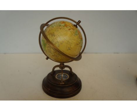 Globe on wooden base with compass