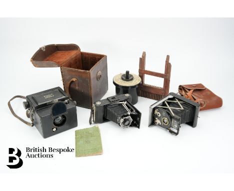 A Victorian W C Hughes magic lantern photographic enlarger with plates, a Newman &amp; Guardia Sibyl camera, Zeiss Ikon Netta