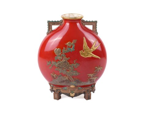 A late 19th century Royal Worcester red ground moon flask. Decorated in the Japanese lacquer style with a bird over flowering