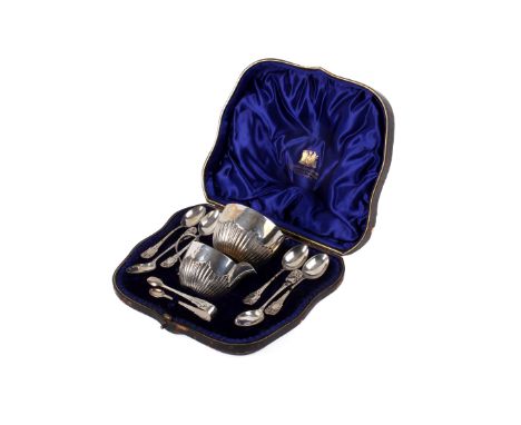 A 1903 silver tea set and a set of six teaspoons. The matching milk jug, sugar bowl and sugar nips with vertical ribbed decor