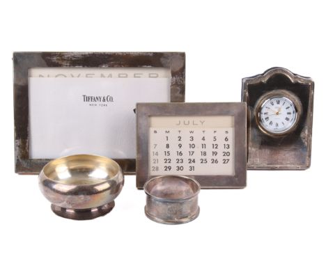 Two silver photograph frames, a table clock and a dish. The first marked TIFFANY & CO, STERLING, and one with the number 2381