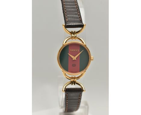A 'GUCCI' WRISTWATCH, quartz movement, red and green round dial, signed 'Gucci', yellow metal case, approximate case width 23