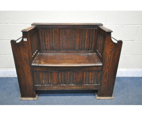 AN EARLY 20THY CENTURY OAK LINENFOLD HALL BENCH, flanked by stick supports, width 113cm x depth 40cm x height 89cm (condition