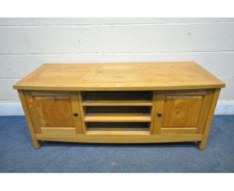 A LIGHT OAK TV STAND, with two fielded panel doors, width 130cm x depth 50cm x height 54cm (condition report: -good)