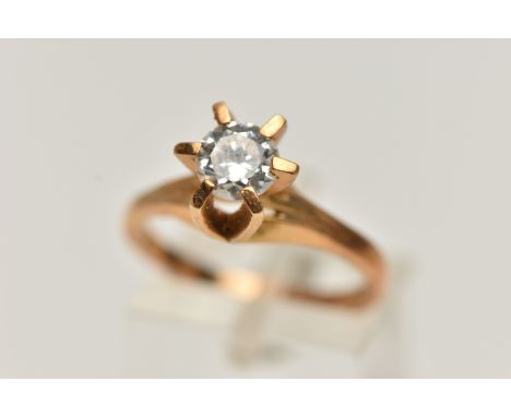 A YELLOW METAL CUBIC ZIRCONIA RING, a single circular cut, colourless cubic zirconia, in a raised six claw setting, trifurcat