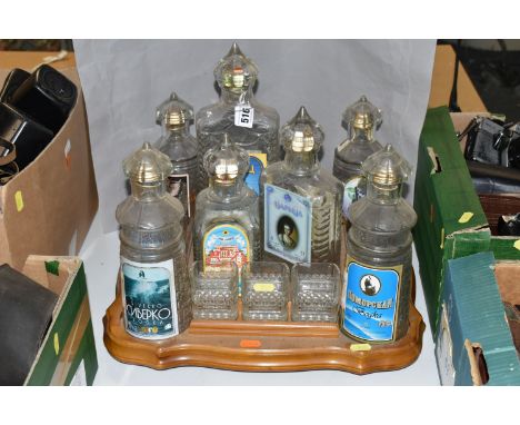 A VINTAGE RUSSIAN SOUVENIR VODKA  SET, in the form of The Kremlin, seven stylised empty decanters, eleven glasses (one missin