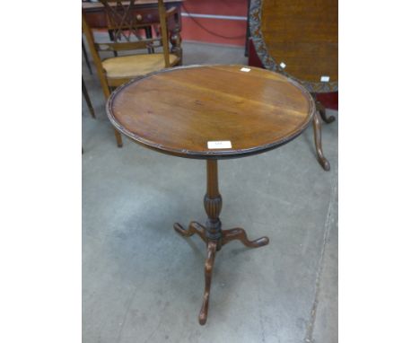 A mahogany circular tripod lamp table