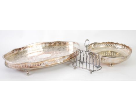 SILVER PLATED ON COPPER TWO HANDLED GALLERIED TRAY, of oval form with chased floral centre and cut-out handles, 16 1/4" x 10 