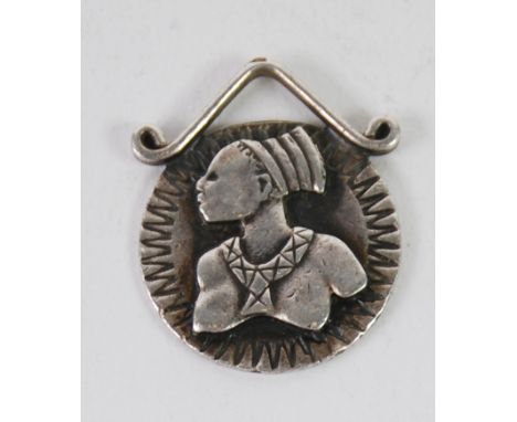 BIRGER HAGLUND (b.1918), STERLING SILVER PENDANT, of circular form with bust portrait of an African female figure, with scrol