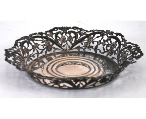 VICTORIAN SILVER DECANTER COASTER, the out scrolled sides pierced and repousse with trailing roses and 'C' scrolls, 7 1/2" di