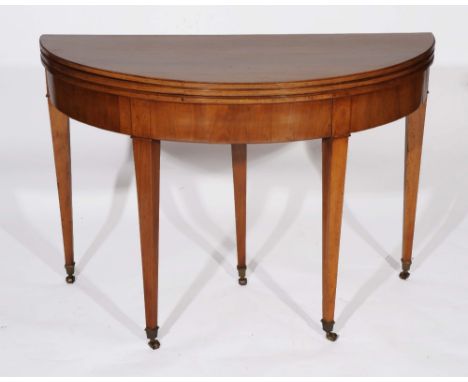 A 19TH CENTURY MAHOGANY TRIPLE DEMI-LUNE FOLDOVER TEA AND CARD TABLE with tapering supports and brass castors, 112cm