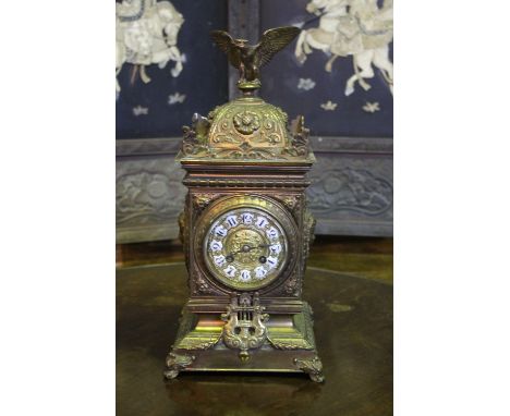 A LATE 19TH CENTURY FRENCH GILT BRASS MANTEL CLOCK with eight day movement and white enamel dial, the square case with eagle 
