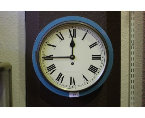 A WALL CLOCK with painted enamel dial with Roman numerals in a blue painted outer case, 24cm