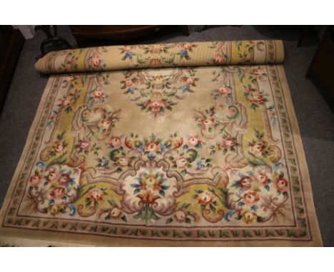 A CHINESE IVORY GROUND SMALL CARPET with floral and foliate border, approximately 183cm x 244cm
