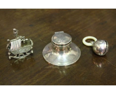 A SILVER CAPSTAN INKWELL (monogrammed Birmingham 1909), together with a silver baby's rattle with mother of pearl teething ri