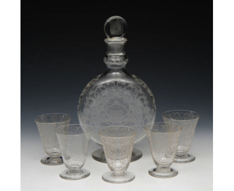 A BACCARAT FLASK SHAPED GLASS DECANTER with etched foliate designs and central heraldic shield, 26cm and five small tapering 