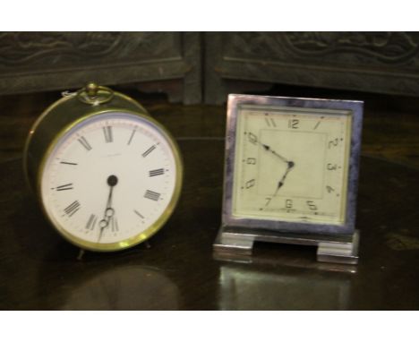 A 19TH CENTURY BRASS CYLINDER CLOCK with enamel dial marked F G Wilson, 13cm diameter and an Art Deco silver plated desk cloc