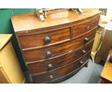 AN EARLY VICTORIAN MAHOGANY BOW FRONT CHEST OF DRAWERS with two short drawers over three long drawers with turned knob handle