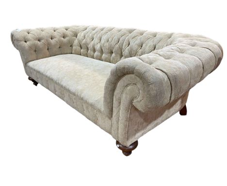 Chesterfield settee in deep buttoned light gold fabric.