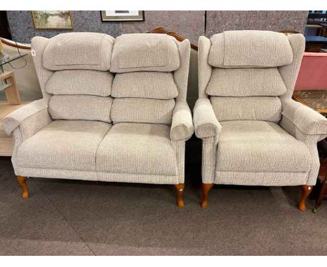 Wing back two seater settee and chair in light fabric.