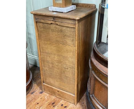 Early 20th Century oak filing cabinet, the roller shutter front enclosing nine drawers, 97cm by 48.5cm by 41cm.