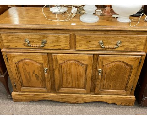 Old Charm carved oak two door cabinet, two drawer console table and oak finish three door sideboard (3).