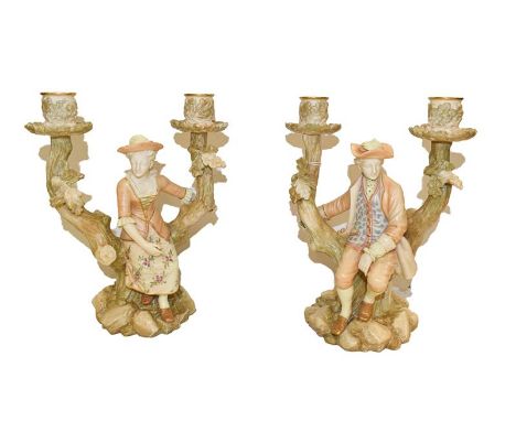 A pair of Royal Worcester candelabra, modelled with figures seated on a tree stump with two sconces to each, date code 1885, 