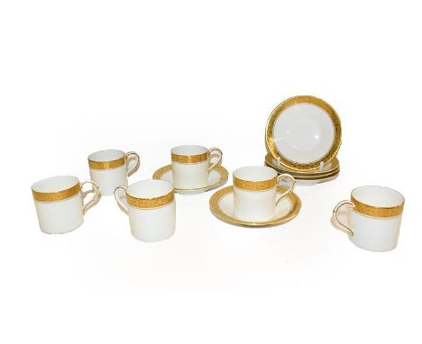 A set of six Royal Worcester coffee cans and saucers decorated with gilt and scrolling, date code 1937, together with a group