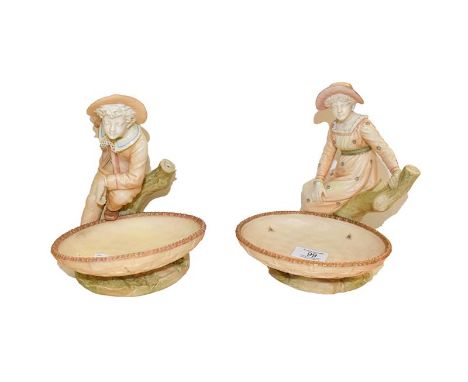 A pair of Royal Worcester comports, modelled as a girl and a boy, puce marks, 21cm  .  Male figure with the basket broken and