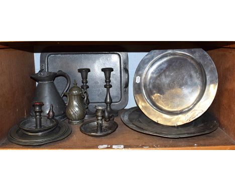 A quantity of pewter comprising chargers, jug, candlesticks, tray, etc (one shelf).  Cone shaped measure 22cm