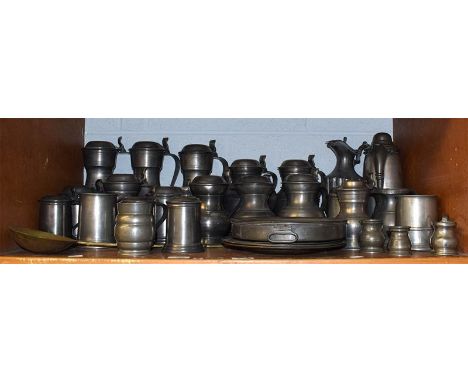 A large quantity of 18th century and later pewter items including flagons, tankards and serving dishes, some with touch marks