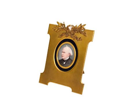 A German porcelain oval plaque, late 19th century, painted with a bust portrait of a gentleman, 4.2cm by 3cm, in a gilt metal