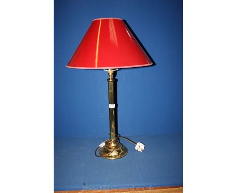 A lamp and shade (maroon), having brass column.
