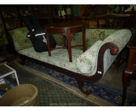 An elegant early 19th c. Mahogany framed double ended Sofa standing on scroll legs terminating in brass castors, well re-upho