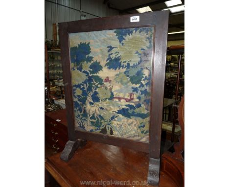 A Fireguard with needlepoint panel.