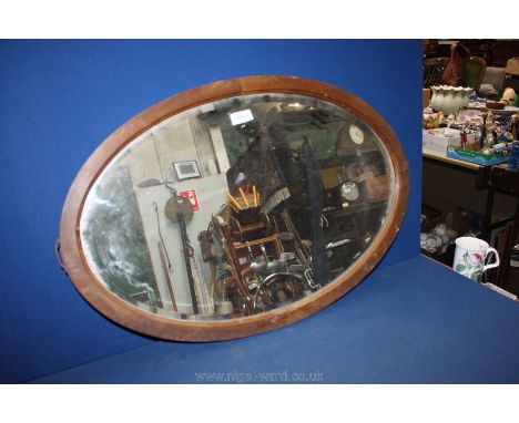 An oval bevelled plated Mirror in hardwood surround.