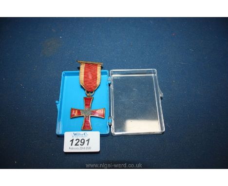 A masonic Knights Templar Medal in red enamel (some damage) with ribbon, bar and pin.