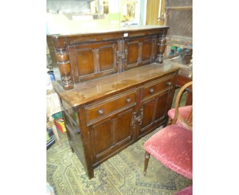 A Ercol (believed) dark-stained Court Cupboard style Sideboard having two frieze drawers with a double doored cupboard below.